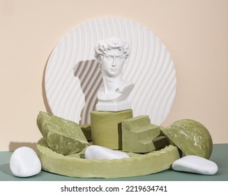 David Bust On A Podium With Plaster Geometric Shapes On A Two Tone Background. Creative Still Life