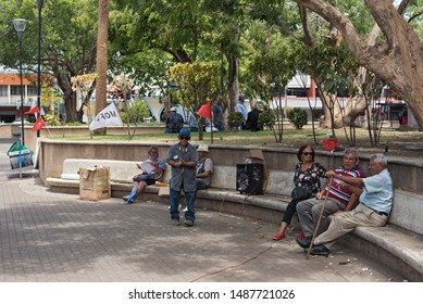 DAVID PANAMA-MARCH 21, 2019: Elderly Panamanese Sitting On A Stone Bench In The Miguel De Cervantes Saavedra Park David Panama