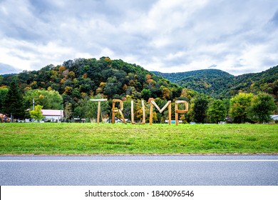 Davis, USA - October 5, 2020: West Virginia Countryside In Tucker County With Republican Trump Presidential Election Wooden Text Sign With Night Illuminations By Rural Mountains Houses