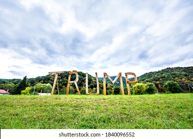 Davis, USA - October 5, 2020: West Virginia Rural Countryside, Tucker County With Republican Trump Presidential Election Wooden Text Sign Letters With Night Illuminations By Mountains Houses