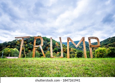 Davis, USA - October 5, 2020: West Virginia Rural Countryside, Tucker County With Republican Donald Trump Presidential Election Wooden Text Sign Letters With Night Illuminations By Mountains Houses