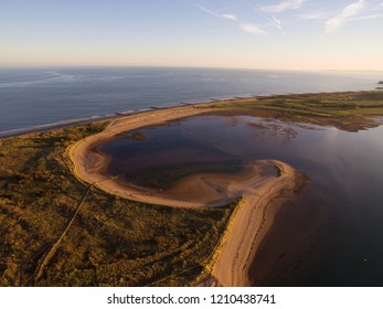 Dawlish warren on the Exe estuary from above by drone in evening sun , in Devon , UK 