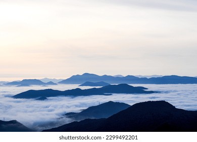 At dawn, I climbed a mountain and saw the sunrise and the sea of clouds,
I put a windmill in the background. - Shutterstock ID 2299492201