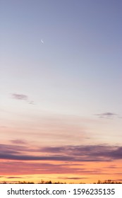 Dawn With Dark Clouds And A Thin Crescent Moon In The Sky.