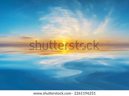 Dawn or dusk reflected on smooth water