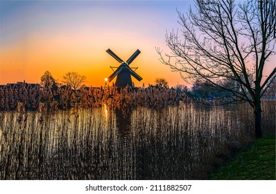 Dawn over the mill by the river. Mill at dawn. Windmill at dawn. Mill farm at dawn