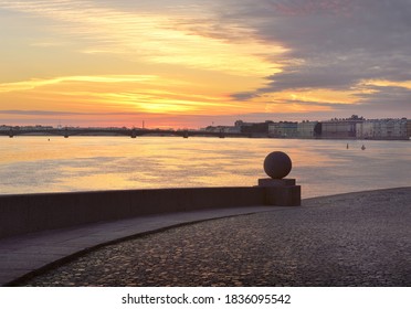 Dawn Over The Neva. View Of The Trinity Bridge And The Palace Embankment From The Spit Of Vasilievsky Island. Granite Parapet With A Stone Ball