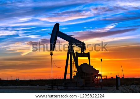 Dawn over petroleum pump.