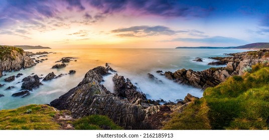 Dawn over the sea horizon and coastal cliff beach. Sea cliff on coastal beach