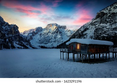 Dawn with a purple sky over the frozen Lago di Braies, or Pragser Wildsee, during winter time without people