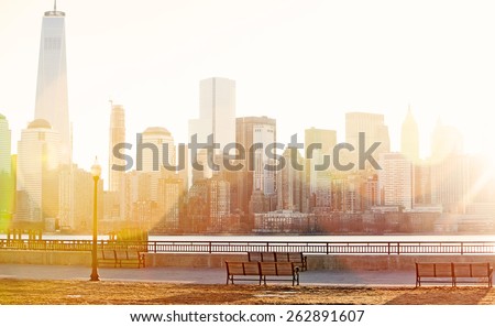 Dawn sunshine breaking over lower Manhattan with natural lens flare