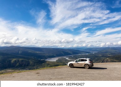 Dawson City, Yukon, Canada - August 27, 2020: Mazda CX-5 on top of a mountain overlooking a beautiful scenic viewpoint during a cloudy and sunny day.