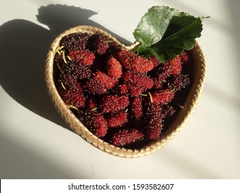 Valentine’s Day Concept, Mulberry Fruits In The Heart Basketery Bamboo,  The Sun Shines From The Bottom Right Of The Image.