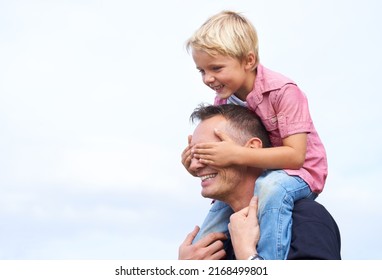 Day With Dad. Shot Of A Playful Father Giving His Son A Piggyback Outside.