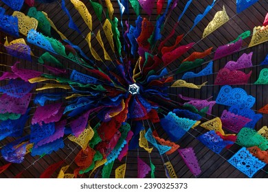 A Day of the dead decorations with colorful papel picado on ceiling of Mexican house - Powered by Shutterstock