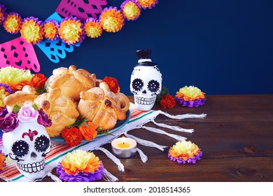 Day Of The Dead, Dia De Los Muertos Celebration Background With Sugar Skull, Calaverita, Marigolds Or Cempasuchil Flowers, Bread Of Death Or Pan De Muerto With Copy Space. Traditional Mexican Culture 