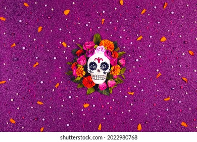 Day Of The Dead, Dia De Los Muertos. Mexican Culture Celebration Glitter Purple Background. Sugar Skull, Calaverita, Marigolds Flowers, Roses. Traditional Festival Flyer. Flat Lay, Top View.