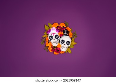 Day Of The Dead, Dia De Los Muertos, Halloween Celebration Background. Sugar Skull, Calaverita, Marigolds Flowers, Purple Copy Space. Traditional Mexican Culture Festival Flyer. Flat Lay, Top View.