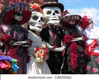 Day of the Dead. People in death masks and skeleton costumes during traditional Mexican holiday Dia de los Muertos