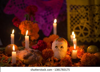 Day of the dead Sugar skull with candles, bread and flowers altar decoration at Janitzio, Michoacan