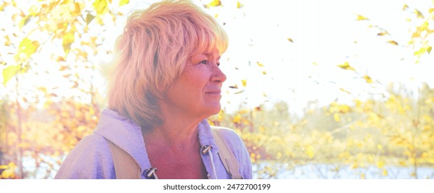 Day dreaming senior  woman outdoors. confident senior woman looking thoughtful during  walking countryside. Travel, vacations - Powered by Shutterstock