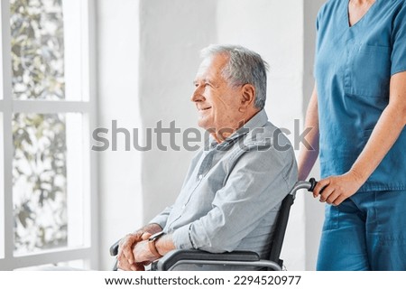 The day feels better after I admire the world. Shot of a nurse caring for a senior man in a wheelchair in a retirement home.