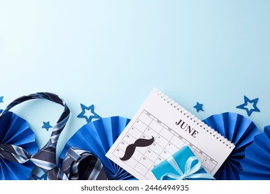 Dad’s day gala: An overhead display of Father's Day party decor with a June calendar, blue stars, striped necktie, mustache cutouts on blue background ready for festive messages - Powered by Shutterstock