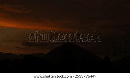 The day is getting darker and is shown by the beauty of the sunset and mountains