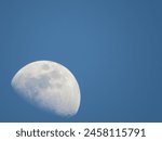 The day moon, a quiet and ethereal presence, graces the sky long after the sun rises. Its pale, ghostly form is often round disc hanging amidst a backdrop of vibrant blue.