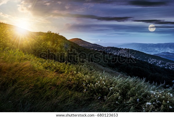 day and night time\
change concept in mountain landscape. grassy meadow on a hillside\
with sun and full moon