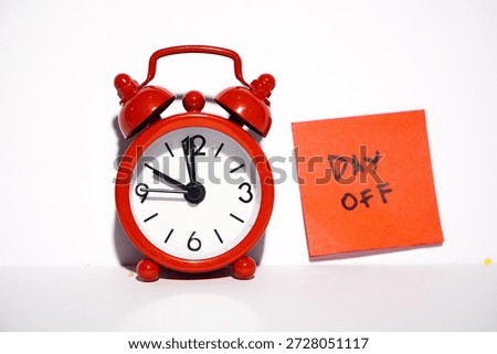DAY OFF from office work concept. Written reminder in red square sticky notes on white background with mini alarm. Annual Leave Schedule Planning To Do List Concept. leave on paper note stick on the calendar. Reminder or Schedule holiday