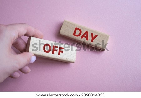Day off symbol. Concept word Day off on wooden blocks. Businessman hand. Beautiful pink background. Business and Day off concept. Copy space