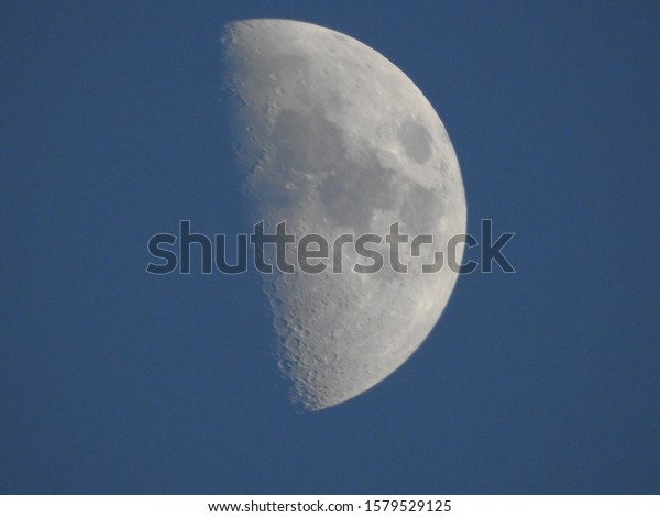 day time moon, with blue hue.\
 