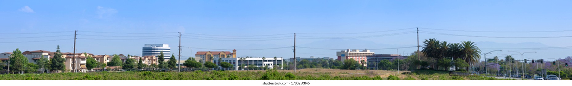 Day time panoramic ground level view of the modern Ontario, California skyline.