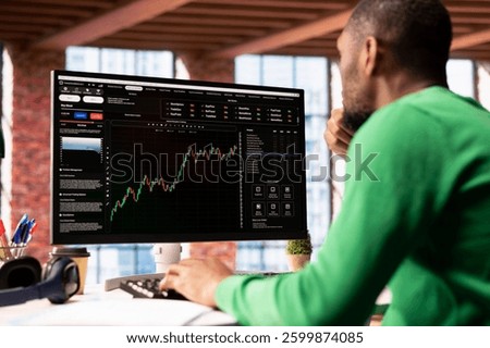 Day trader using computer, purchasing stocks that might perform well and selling ones that might drop in value. Forex trader browsing though stock exchange portfolio pages at PC desk