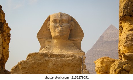 Day view of the Great Sphinx with the Great Pyramid of Giza in the background - Giza, Egypt.