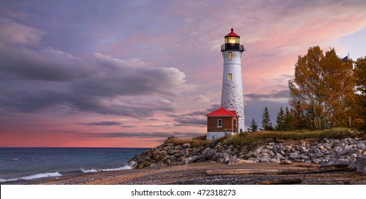 As daylight begins yielding to twilight, The Crisp Point Lighthouse at sunset on Lake Superior, Upper Peninsula, Michigan, USA - A one hour drive from Tahquamenon Falls, mostly dirt roads - Shutterstock ID 472318273