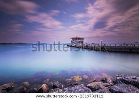 Daylight colored long exposure view of historical Moda Pier. And the view of people and boats during this exposure. Kadikoy, Istanbul.