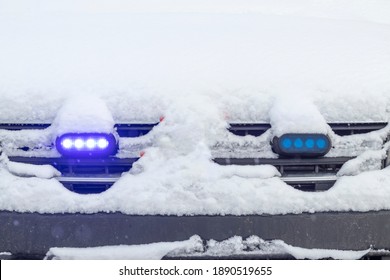 Daylight. Police Siren Blue Under The Snow. Close-up