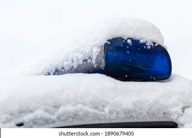 Daylight. Police Siren Blue Under The Snow. Close-up