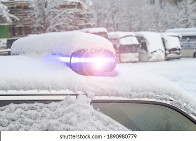 Daylight. Police Siren Blue Under The Snow. Close-up