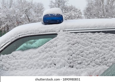 Daylight. Police Siren Blue Under The Snow. Close-up