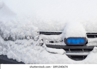 Daylight. Police Siren Blue Under The Snow. Close-up