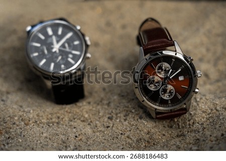 Daylight Saving Time (clock): Two stylish business watches with different time settings to represent the time change. It's not long until the summer, winter time change will happen