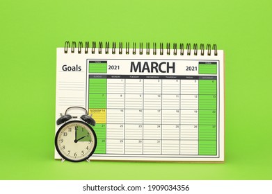 Daylight Savings Time March 2021 Calendar And Alarm Clock On Green Background