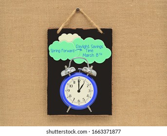 Daylight Savings Time March 8 Clock Blackboard Sign Hanging On Canvas Background