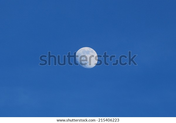Daytime moon blue\
sky