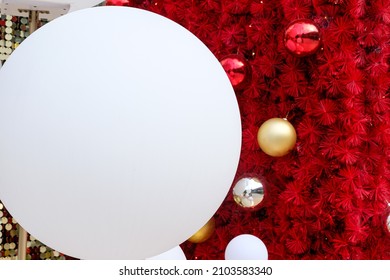 Daytime Outdoor Christmas Decoration With White Big And Small Round Balls On Red Background