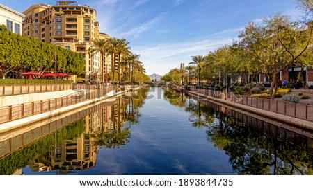 Daytime scene of canal running through waterfront district of Old Town Scottsdale, Arizona USA with condo housing, retail and restaurants