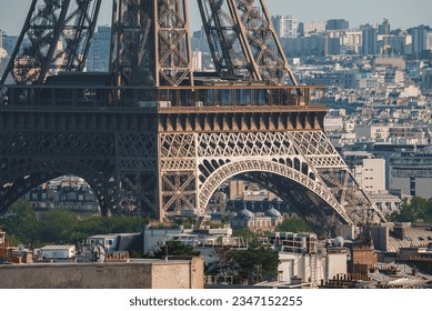 Daytime view of the Eiffel Tower in Paris, France with the Arc de Triomphe in the distance.